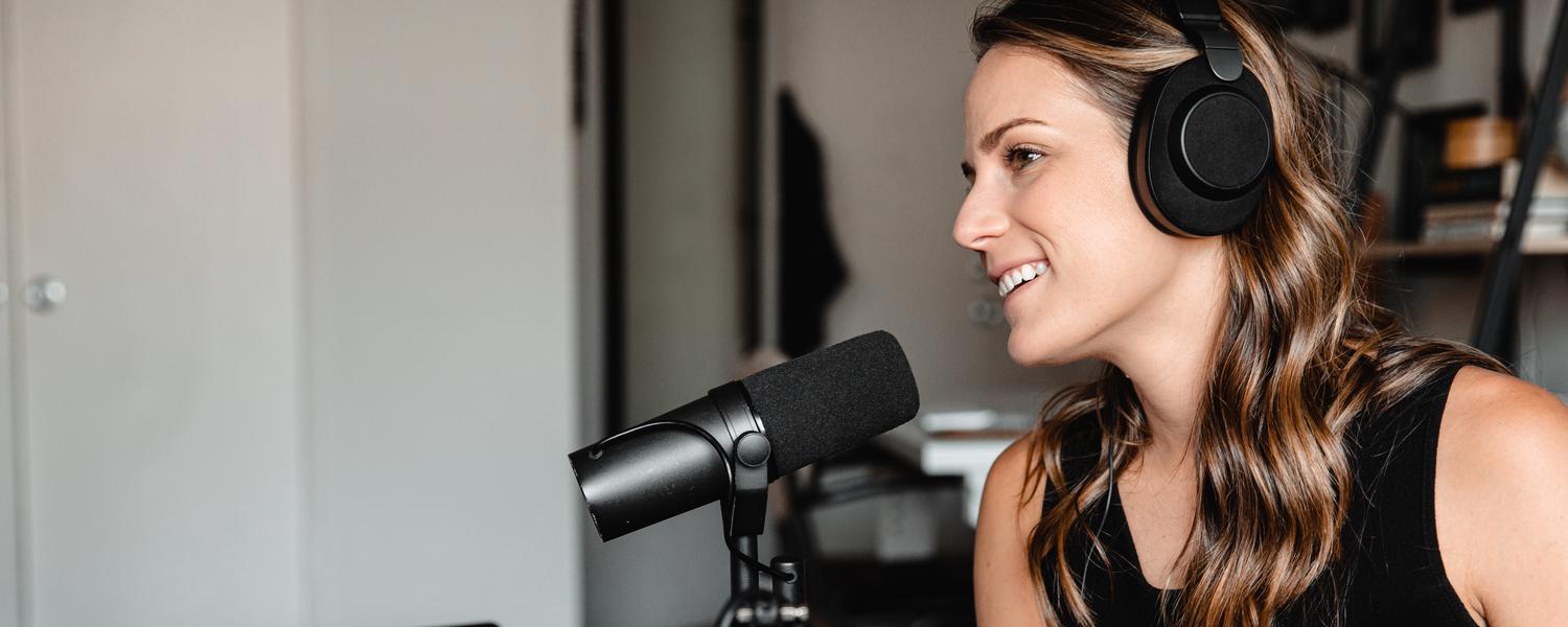Women at a podcast microphone