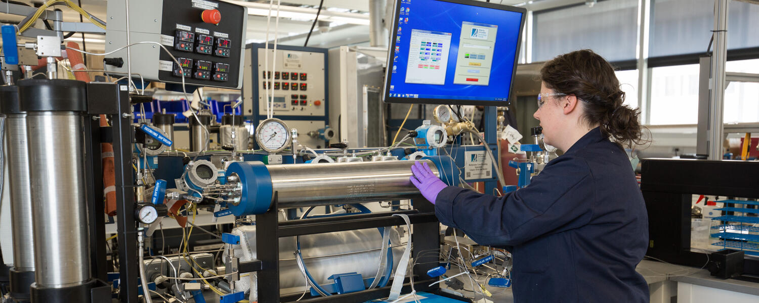 A person works on equipment in a lab