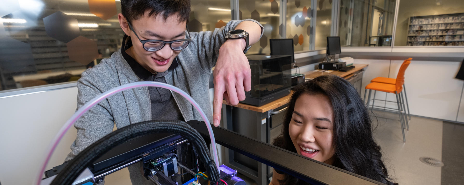 Students using a 3D printer