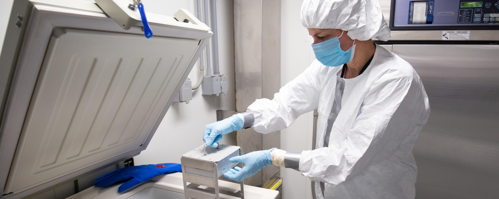 putting samples into a freezer in the lab