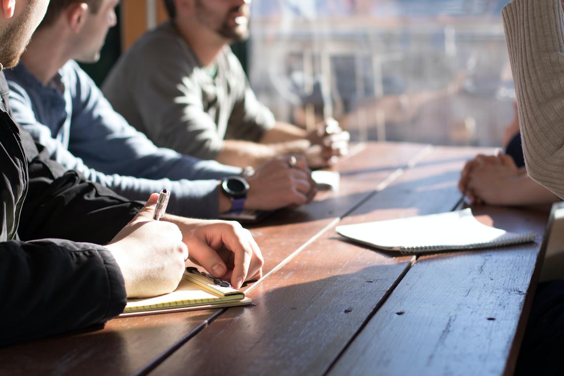 People brainstorming at a boardroom table.