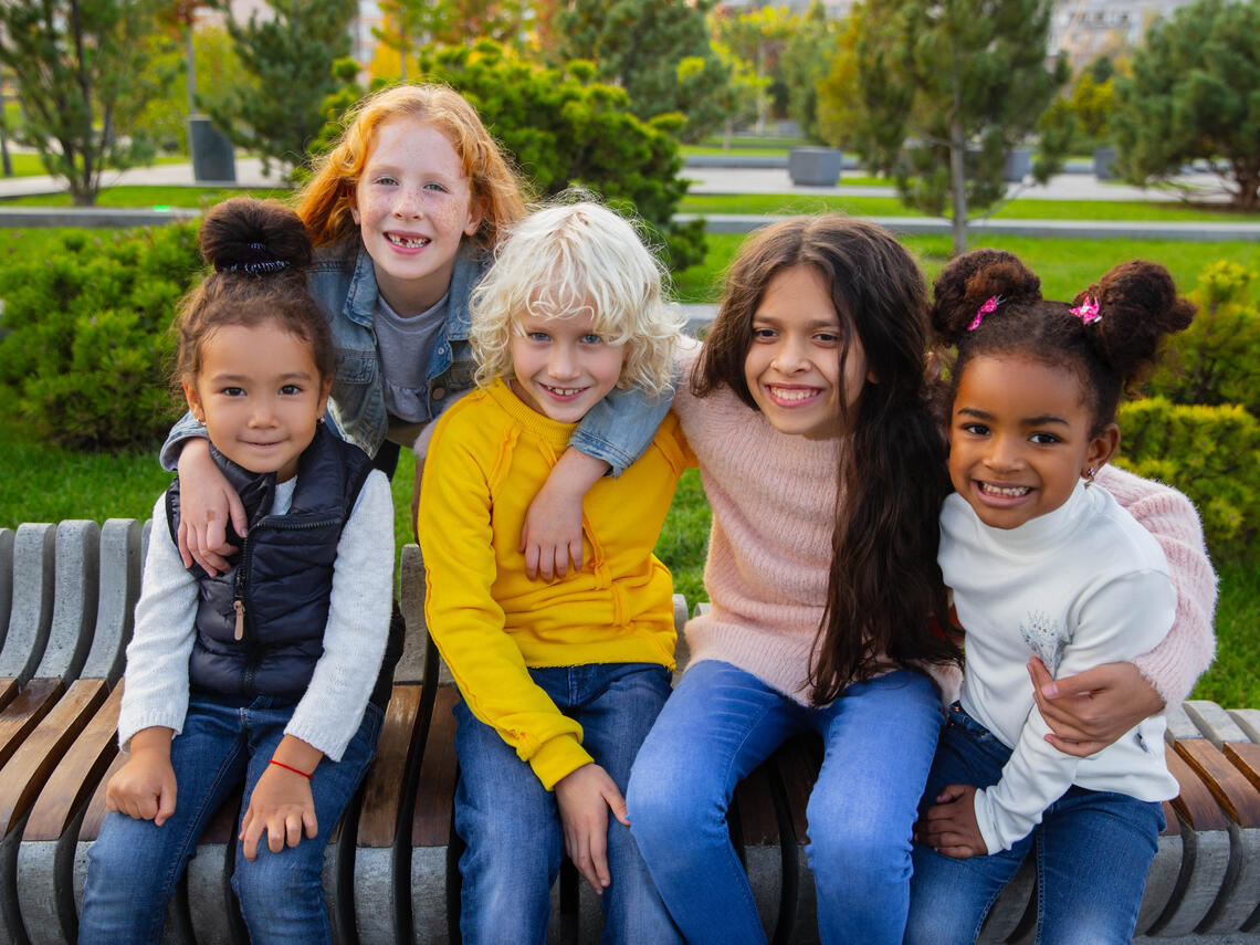 kids sitting outside on bench