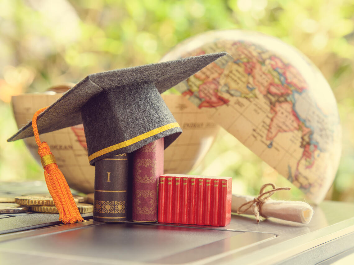 Books, a globe and a university cap 