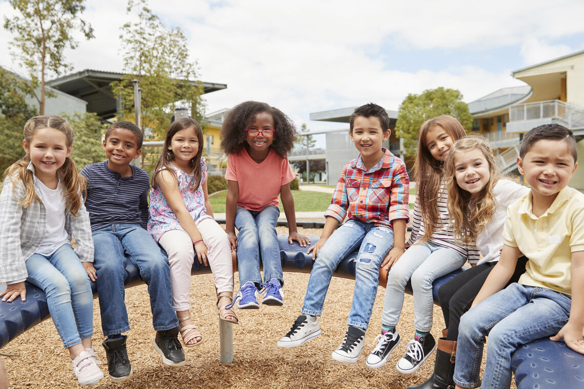 kids sitting outside on playground