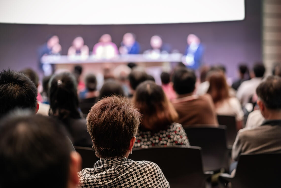 People listening to a panel discussion