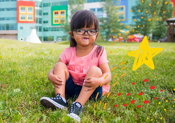 Everly Tram sitting outside Alberta Children's Hospital