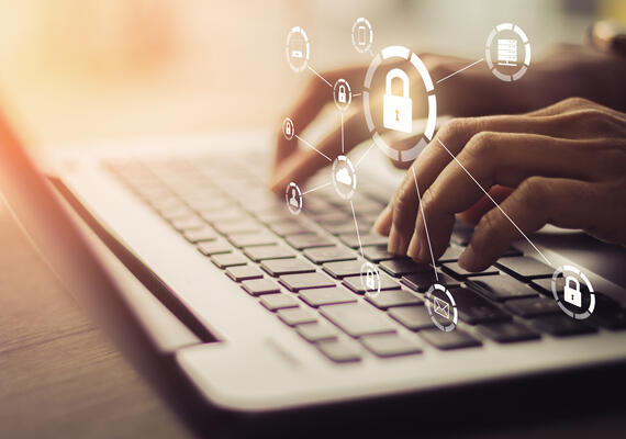 Image of hands typing at a laptop