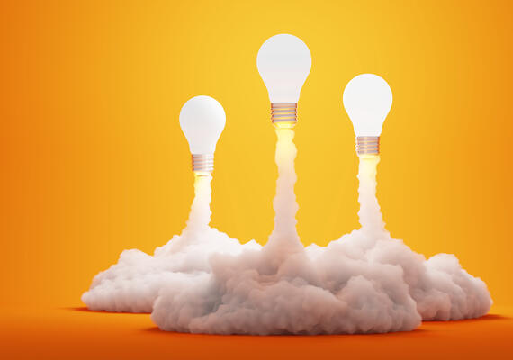 Light bulbs launching like rockets from clouds of smoke