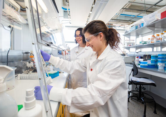 Two people in a lab testing a wastewater sample